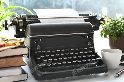 Preview: Vintage manual typewriter on desk with books - writer author concept