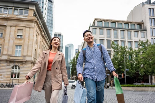 Preview: Asian young man and woman shopping goods outdoors in department store.