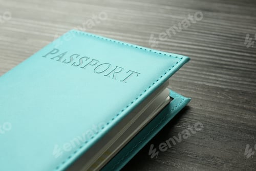 Preview: Passport in turquoise cover on wooden table, closeup