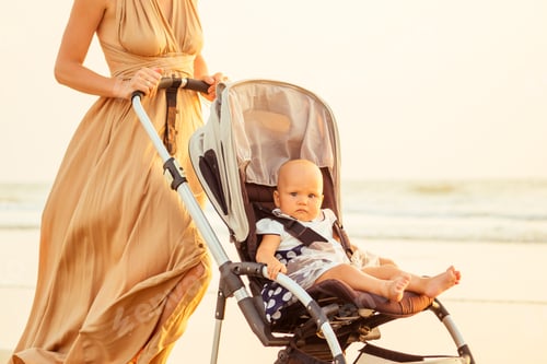 Preview: beautiful mother and her cute child walking before going to sleep on the beach