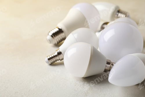 Preview: Energy saving bulbs on white textured background