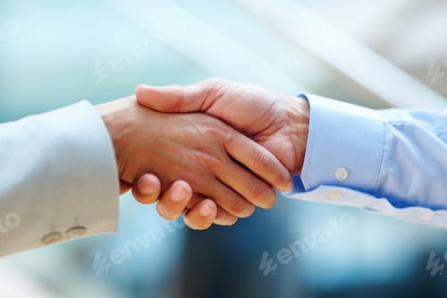 Preview: Youve got yourself a deal. Cropped shot of two people shaking hands in a corporate environment.