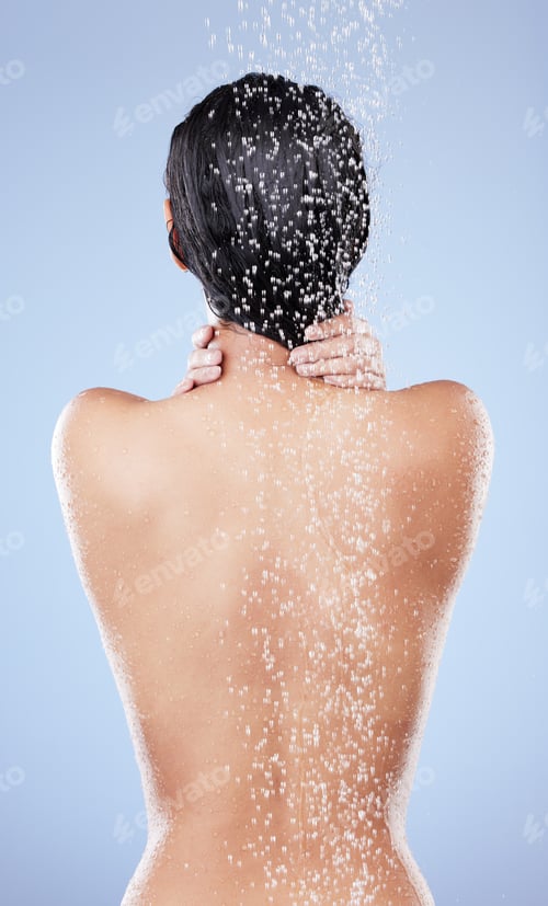 Preview: Shot of an unrecognizable woman washing her hair in the shower against a blue background