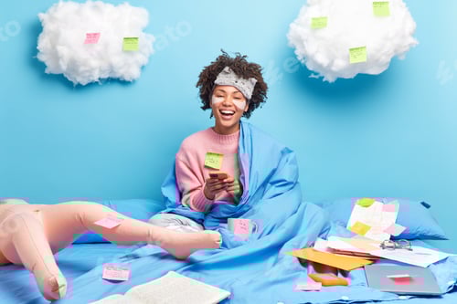 Preview: Positive schoolgirl smiles broadly applies collagen patches for reducing wrinkles holds modern cellp