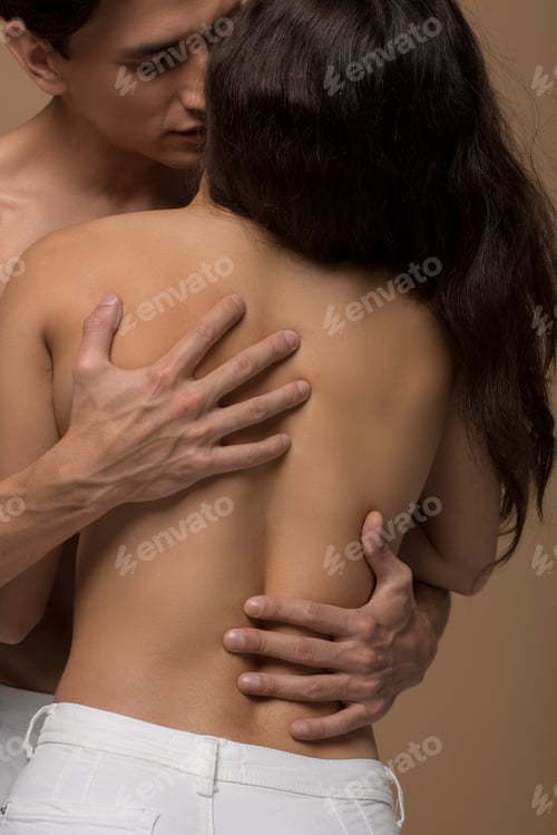 Preview: handsome man hugging sensual nude girl, isolated on beige