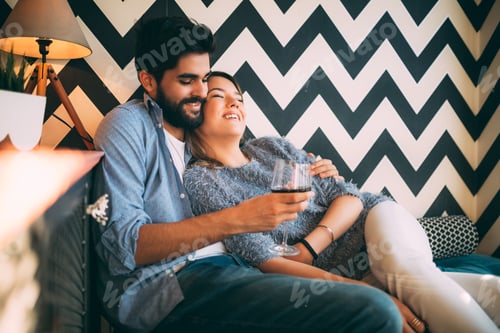 Preview: Affectionate Young Couple Relaxing Together with Red Wine