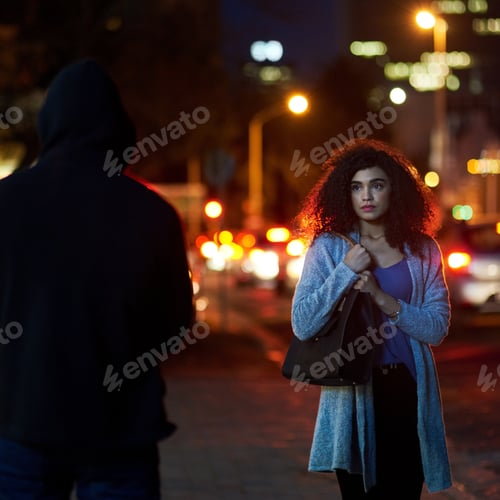 Preview: Shes been targeted. Cropped shot of a frightened young woman being targeted by a thief.