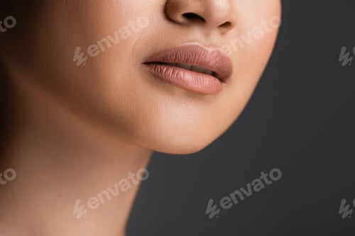 Preview: Cropped view of young woman with makeup isolated on grey