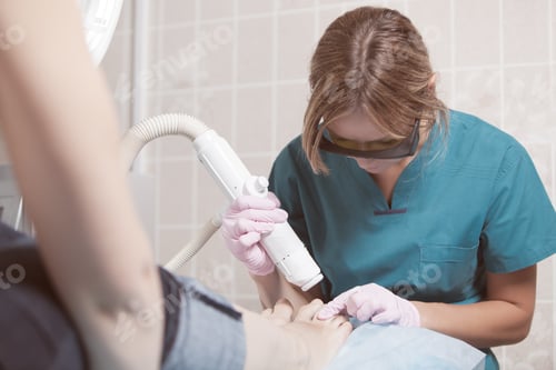 Preview: Medical Professional Working with Laser Equipment on Foot