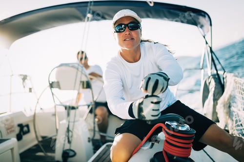 Preview: Woman Sailing Boat Steering on Blue Ocean Water