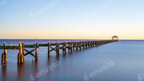 Preview: Serene pier at sunset with seagulls