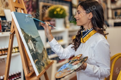 Preview: Adult woman, making a painting of a town.