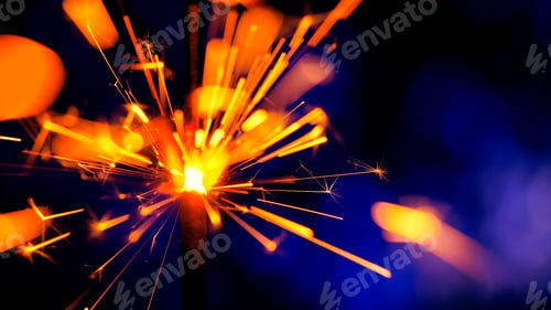 Preview: Sparkler Over Violet. Gun powder sparks shot against deep dark background. Burning fuse bengal fire