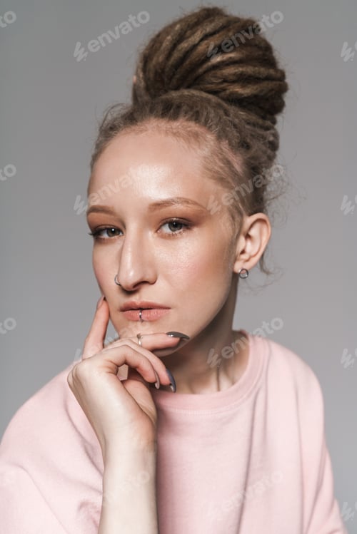 Preview: Woman with Piercings and Dreadlocks Posing in Studio