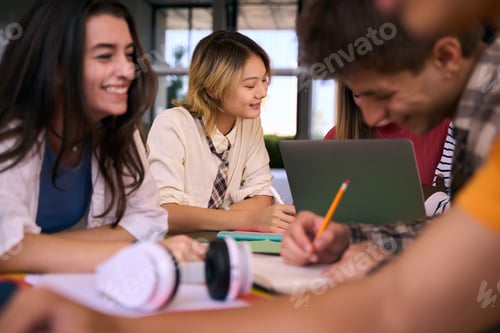 Preview: Group of Generation z language students gathering doing common homework together in study room
