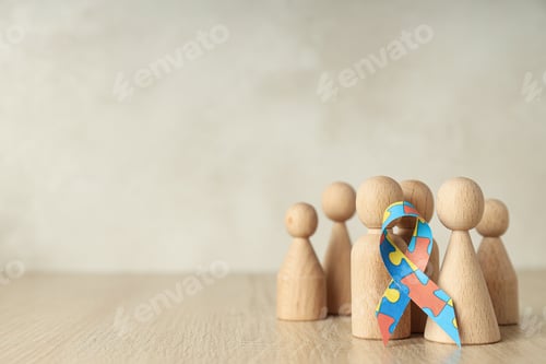 Preview: Ribbon with colorful puzzle pieces and wooden figures on light background, place for text
