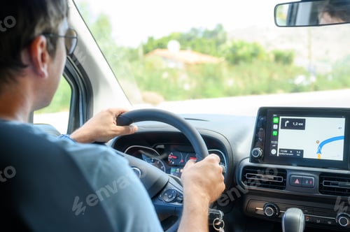 Preview: a male driver travels by car at the wheel with a Navigator