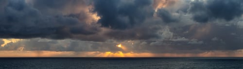 Preview: Dramatic Panoramic View of a cloudscape during a dark, rainy and colorful sunrise
