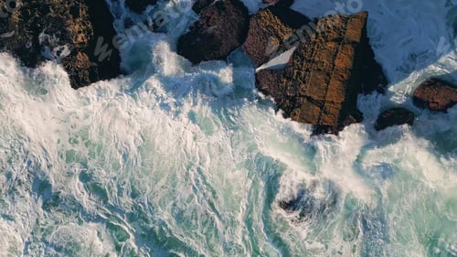 Preview: Foaming sea crashing cliff slow motion. Aerial view foamy water splashing shore