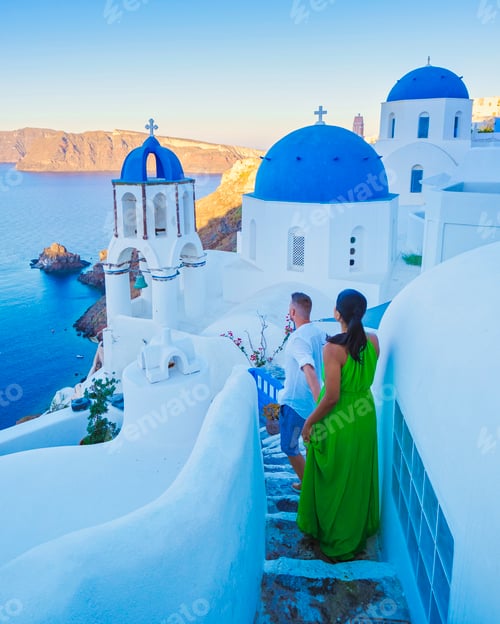 Preview: Couple walking at the Greek village of Oia Santorini Greece, men and women on vacation in Greece