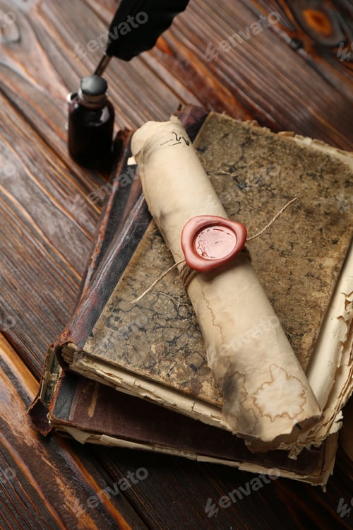 Preview: Old rolled scroll, feather, inkwell and books on wooden table, closeup