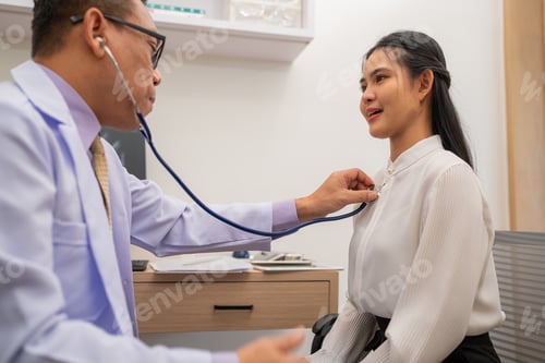 Preview: Doctor using stethoscope to listen heartbeat of elderly patient.