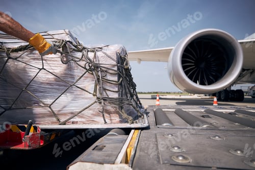 Preview: Cargo containers against jet engine of freight airplane