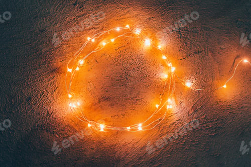 Preview: Warm light illuminated garland close up on dark background
