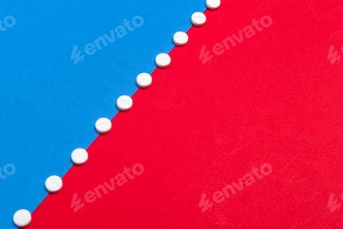 Preview: White medical pills on a two color red and blue background