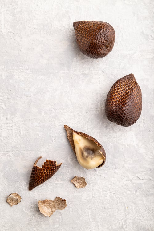 Preview: Salak or snake fruit on gray concrete background. Top view, close up.
