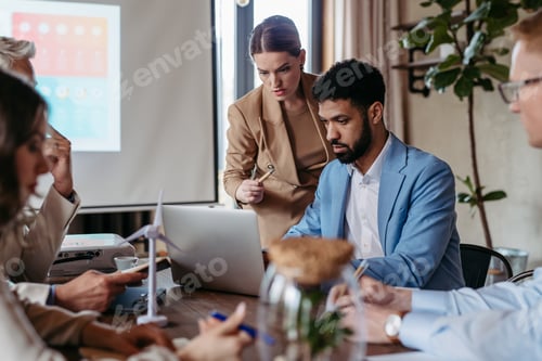 Preview: Young colleagues having meeting, consulting about green energy.