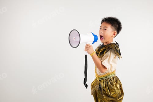 Preview: Portrait Thailand kid boy smiling traditional Thai dress costume shouting by megaphone, studio shot