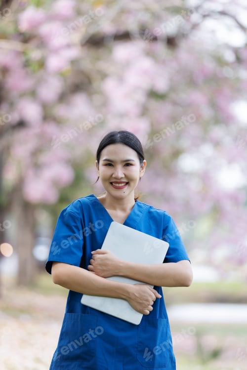 Preview: Nurse holds laptop and is ready to work with confidence