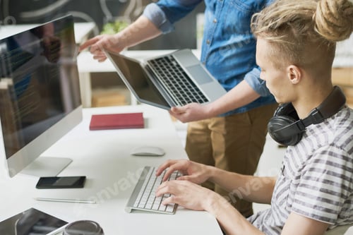 Preview: Colleagues coding information in office