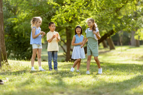 Preview: Group of asian and caucasian kids having fun in the park