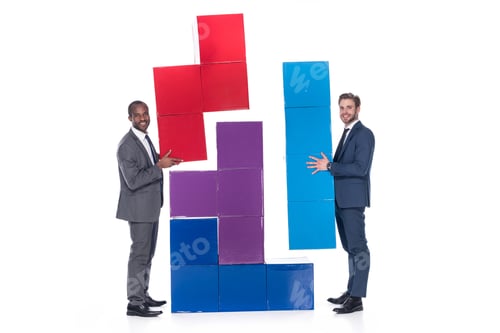 Preview: side view of smiling multiethnic businessmen with colorful blocks isolated on white, teamwork