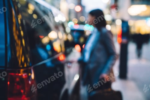 Preview: Young woman standing in front of car