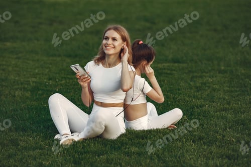 Preview: Mother with daughter listen a music in a park