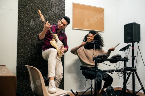 Preview: Man playing guitar and woman playing drums