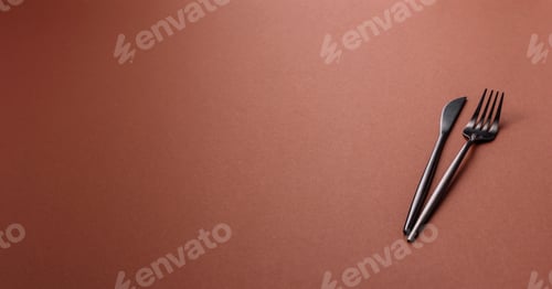 Preview: Knife and fork, cutlery on a brown dining table