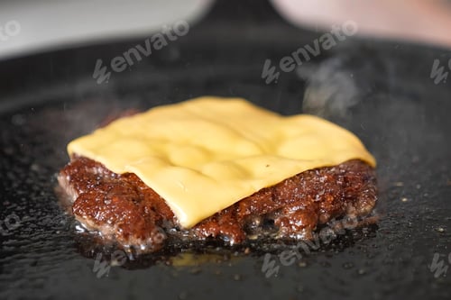 Preview: Cooking burger beef, toast on a hot frying pan close up. Preparing burger patty, homemade. Grocery p
