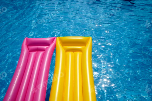Preview: Two airbeds floating in pool, elevated view