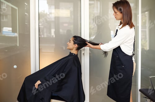 Preview: Woman Styling Another Woman's Hair in a Salon