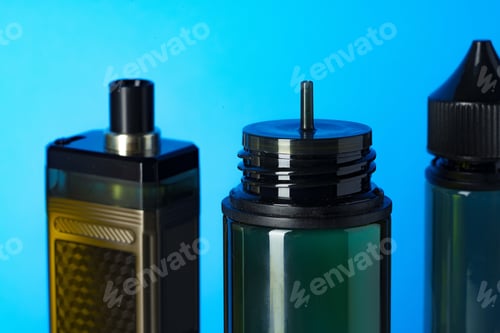 Preview: Black electronic cigarettes liquid bottles on blue background
