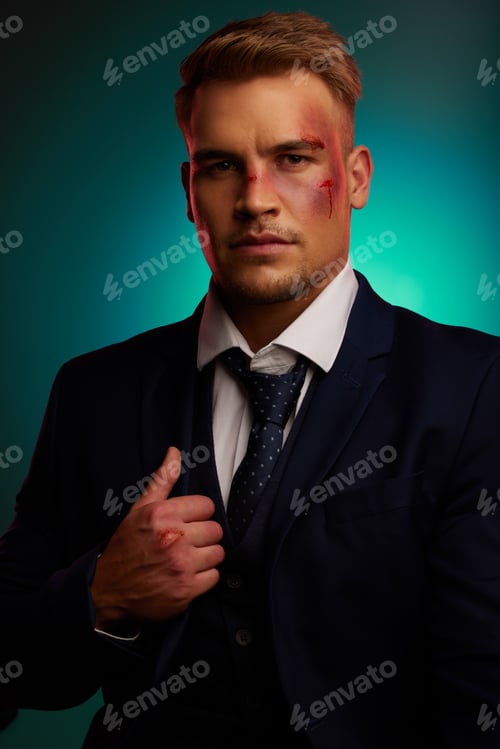 Preview: Shot of a handsome young man standing alone in the studio and posing with a bruised face