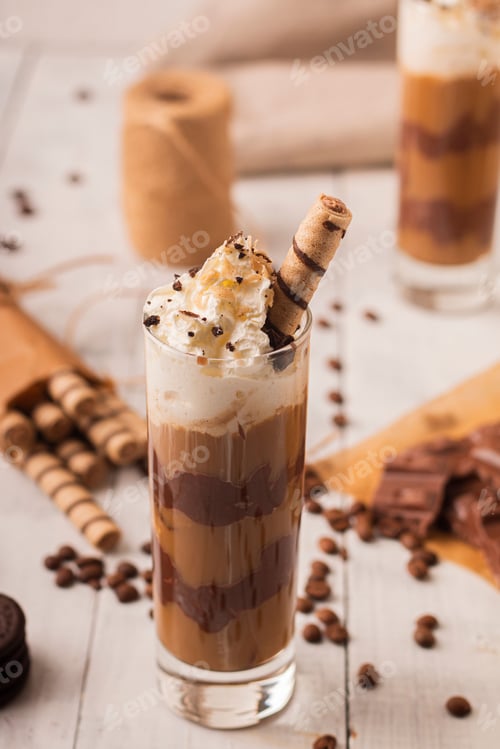 Preview: Vertical shot of a delicious chocolate cocktail with cream and waffle stick