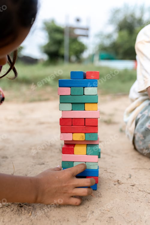 Preview: Indian girls playing concentrated stack wooden block game