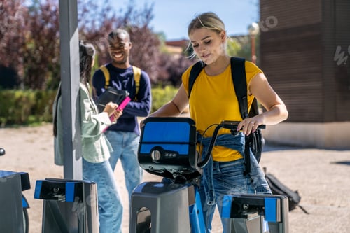 Preview: University student unlocking shared electric bike on campus