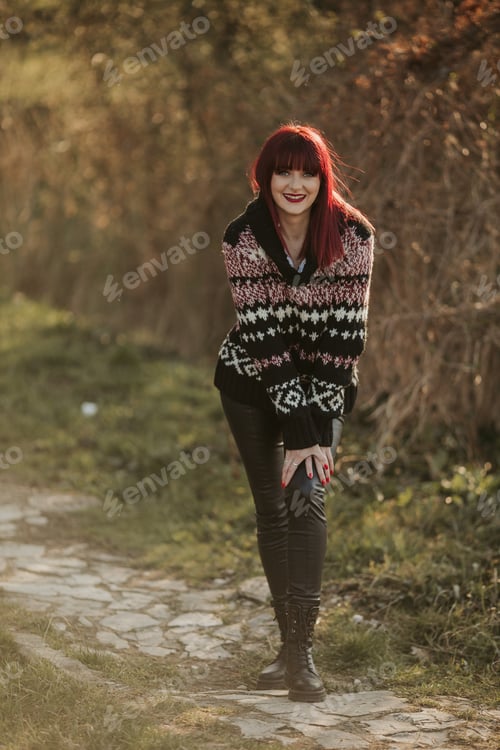 Preview: Vertical shot of a Caucasian red-haired woman on a blurred background