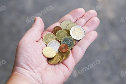 Preview: handful of small loose pocket change euro cent coins in palm of hand